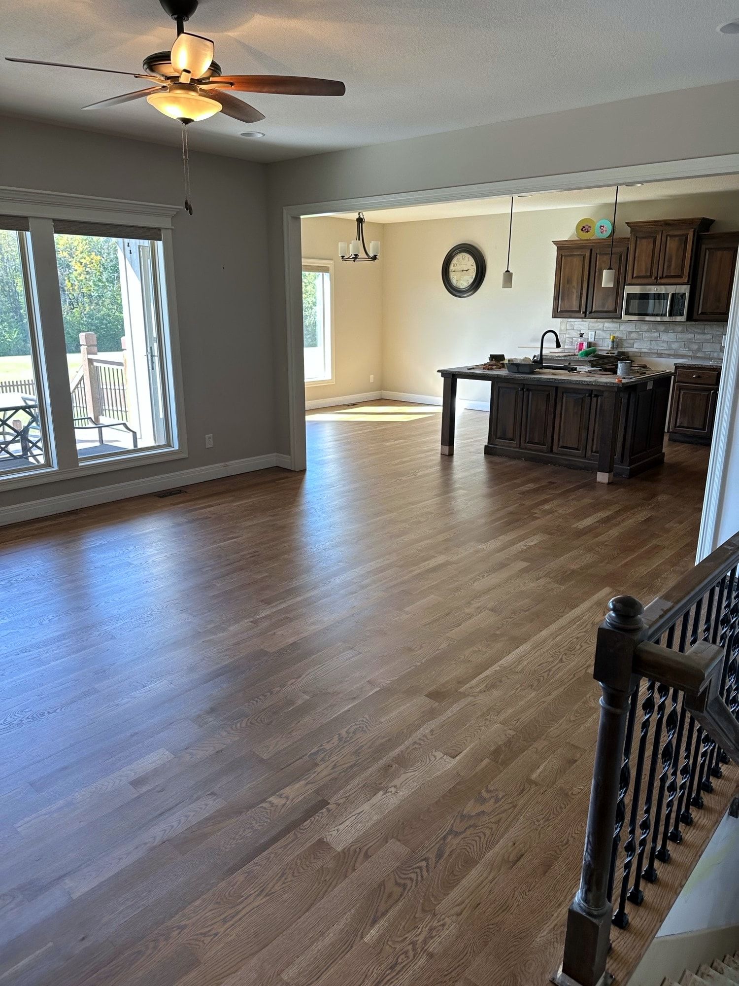 Refinished hardwood floors running through the open main level in a Holden, Missouri whole home remodel