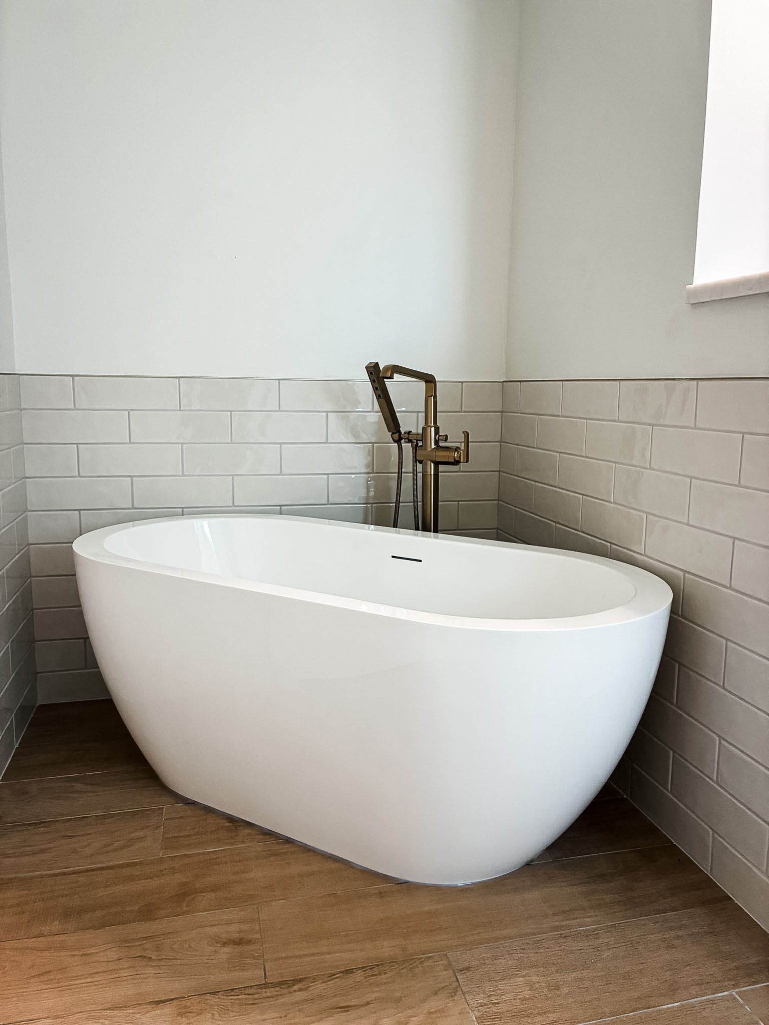Bathtub and tile surround in a Lee's Summit bathroom remodel by Resurrection Homes.