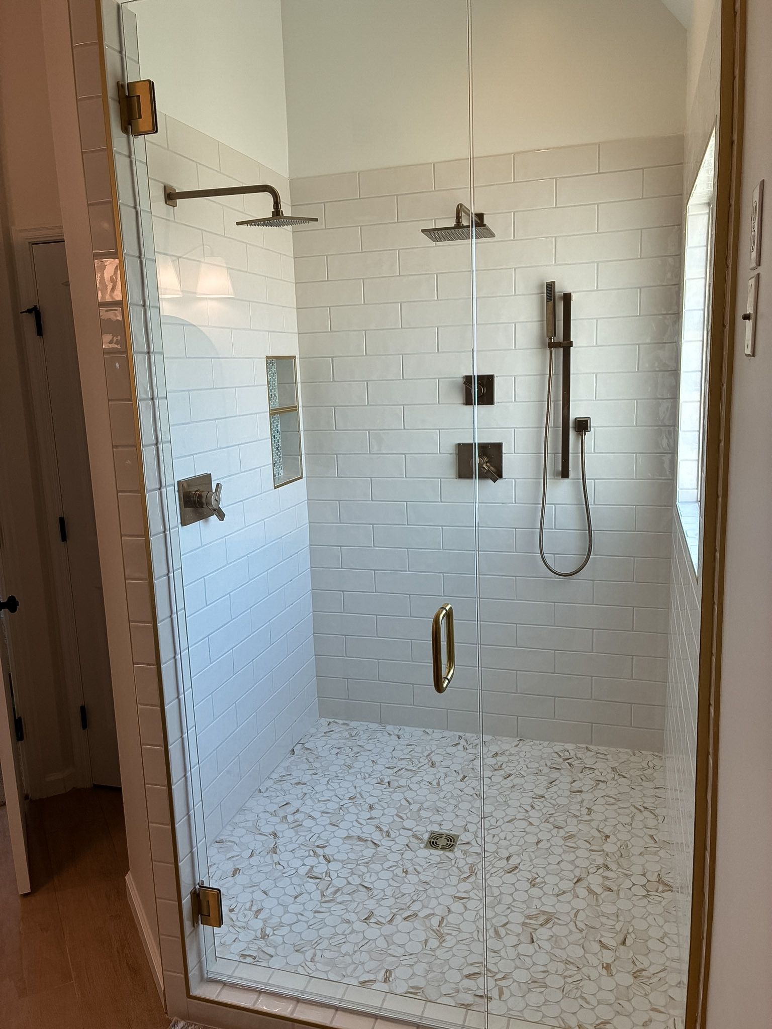 Tile walk-in shower in a Lee's Summit bathroom remodel by Resurrection Homes.
