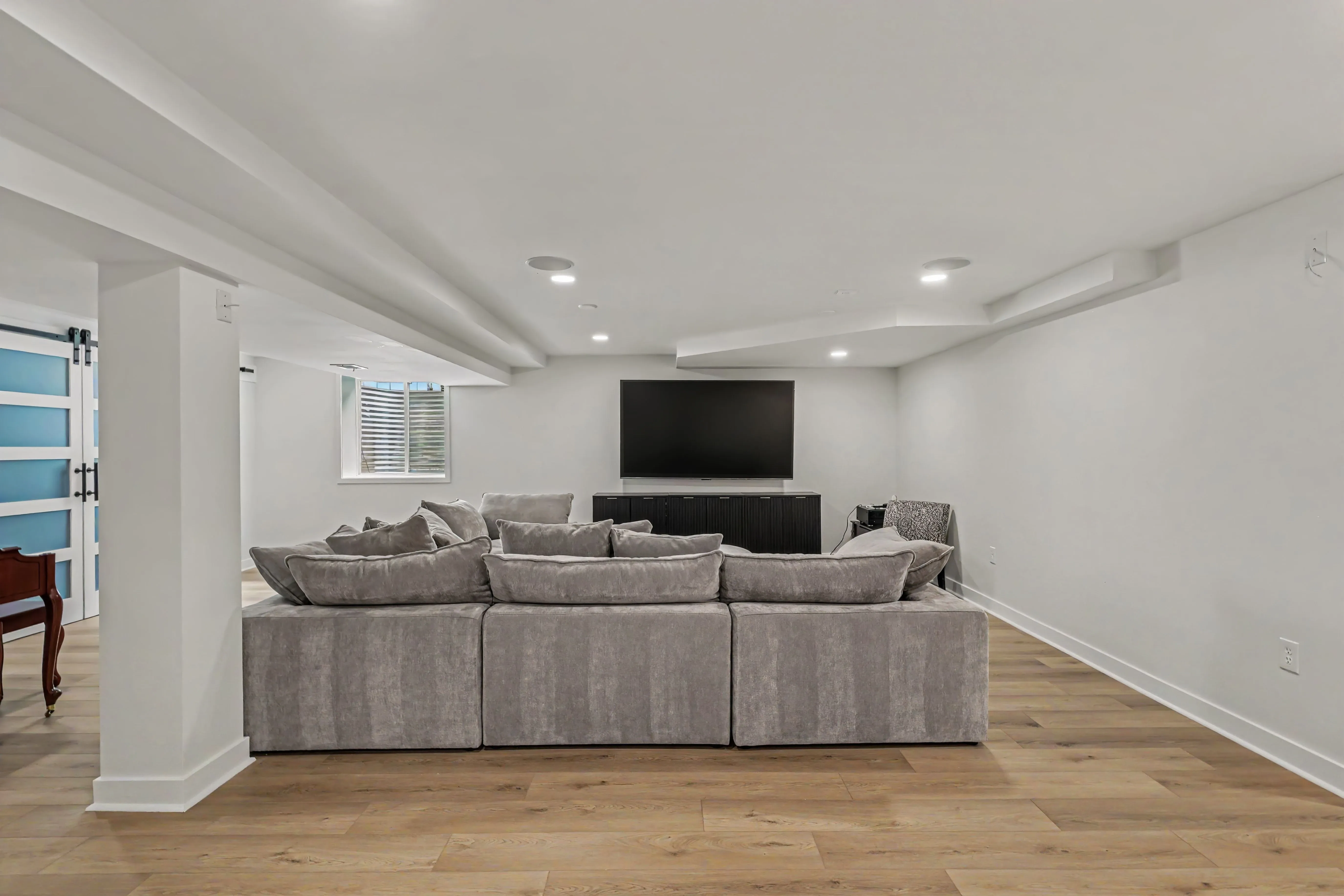 Frosted glass barn doors on a flex room in a finished Prairie Village basement remodel