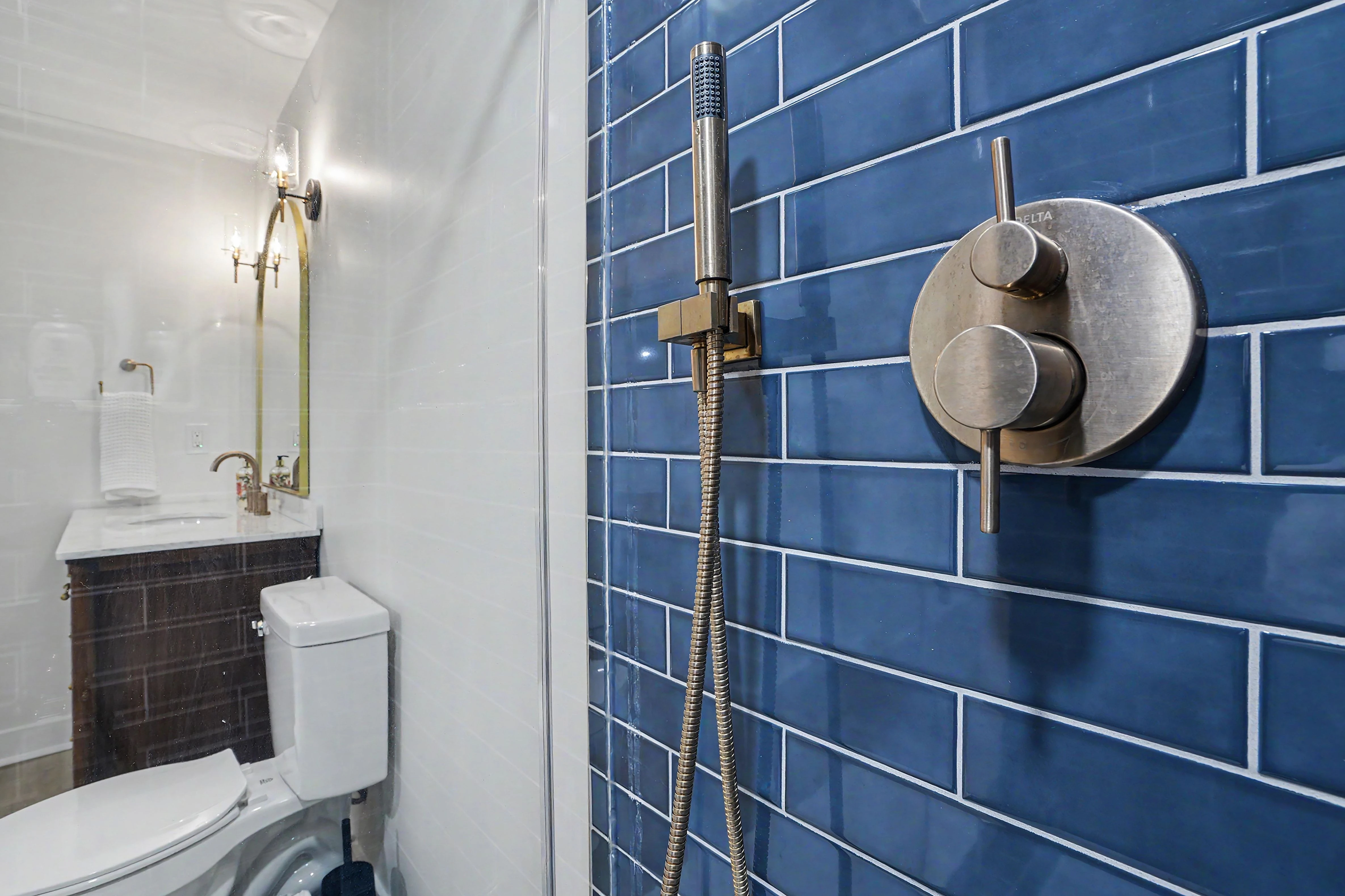 Custom tiled shower interior with handheld sprayer in a Prairie Village basement remodel bathroom