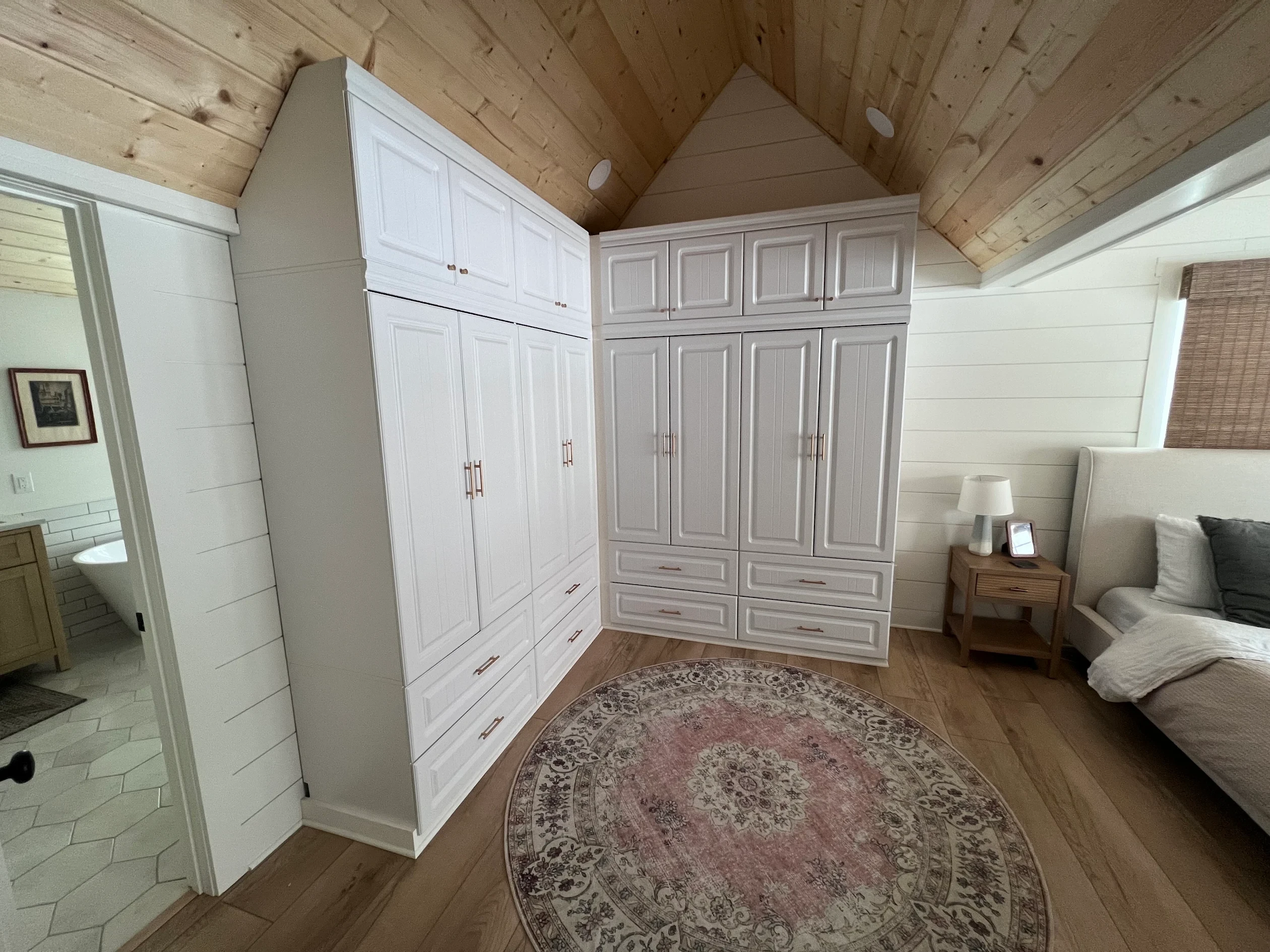 Custom built-in wardrobe cabinetry in a remodeled primary suite