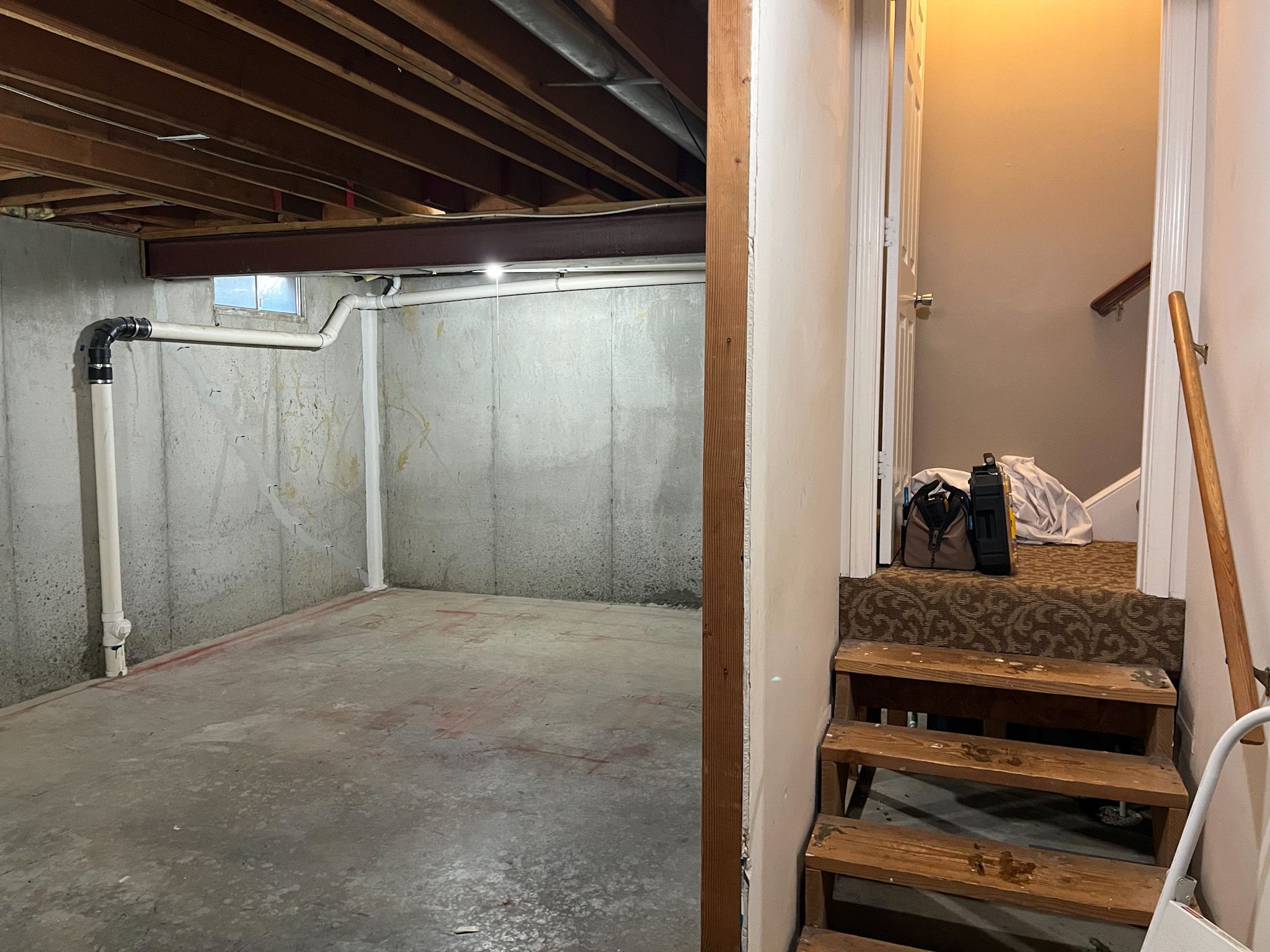 Unfinished basement before remodeling in a Raymore home by Resurrection Homes.