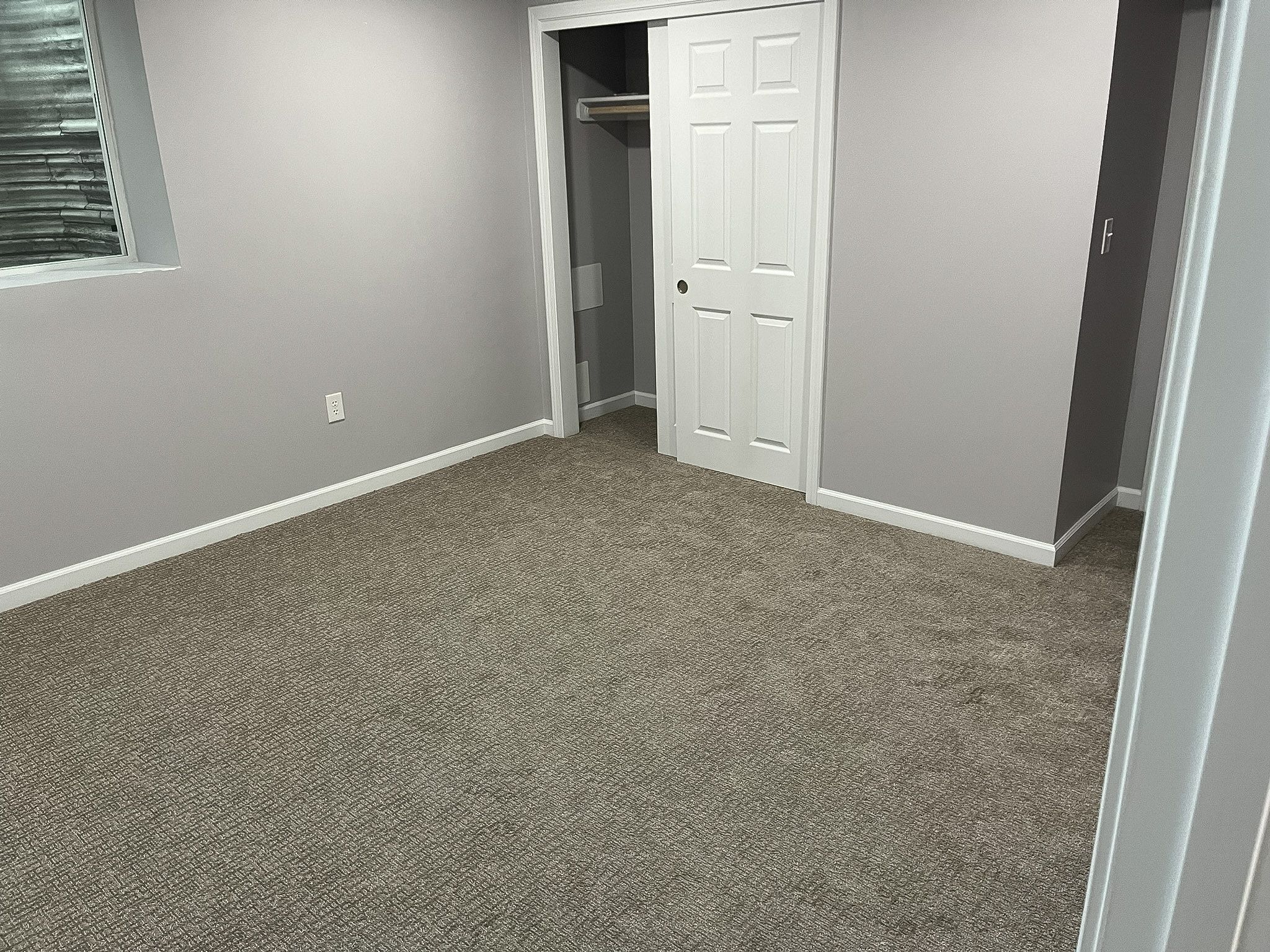 Completed basement remodel with bedroom and bath in a Raymore home by Resurrection Homes.