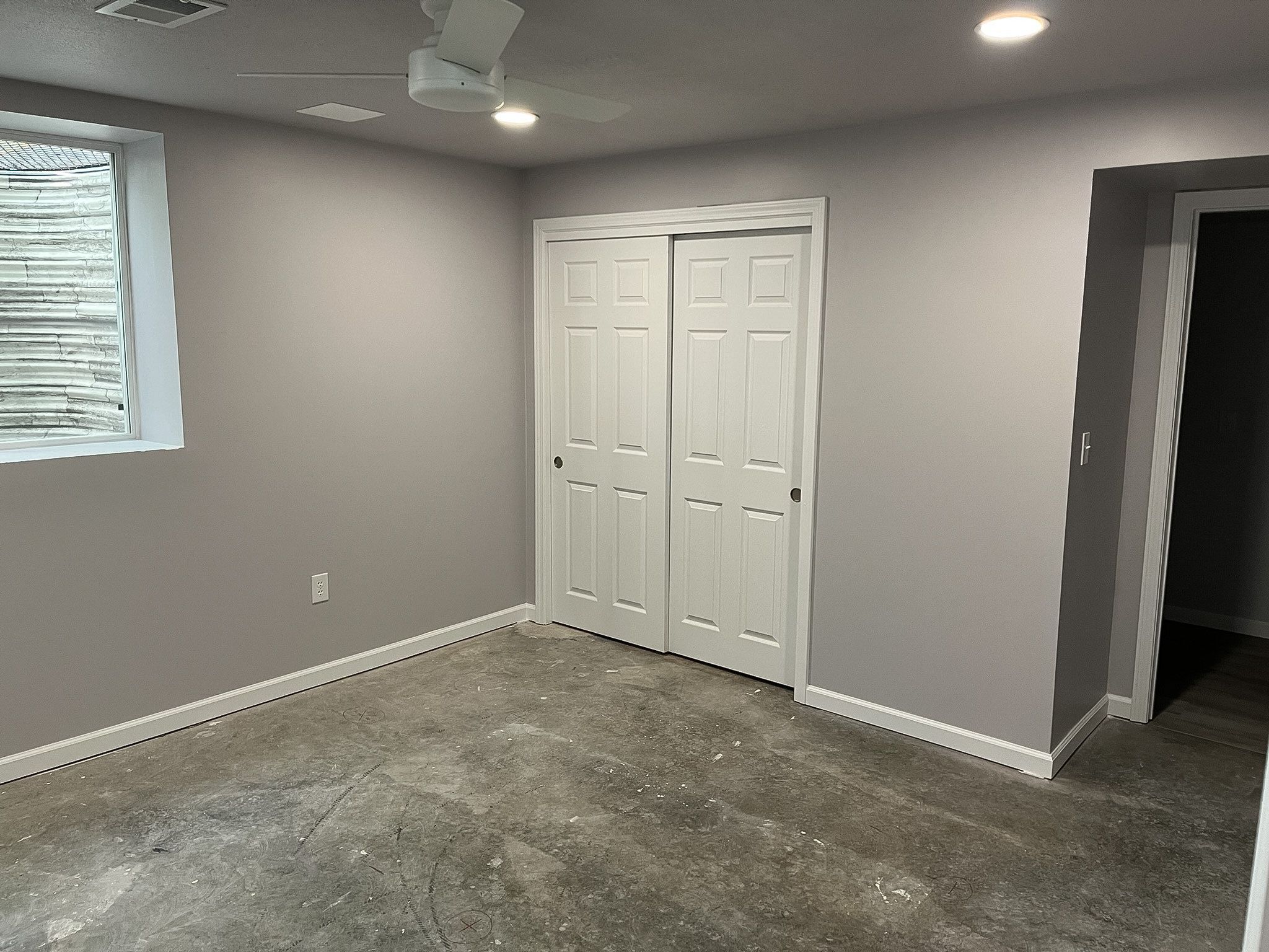 Painted and finished walls in a Raymore basement remodel by Resurrection Homes.