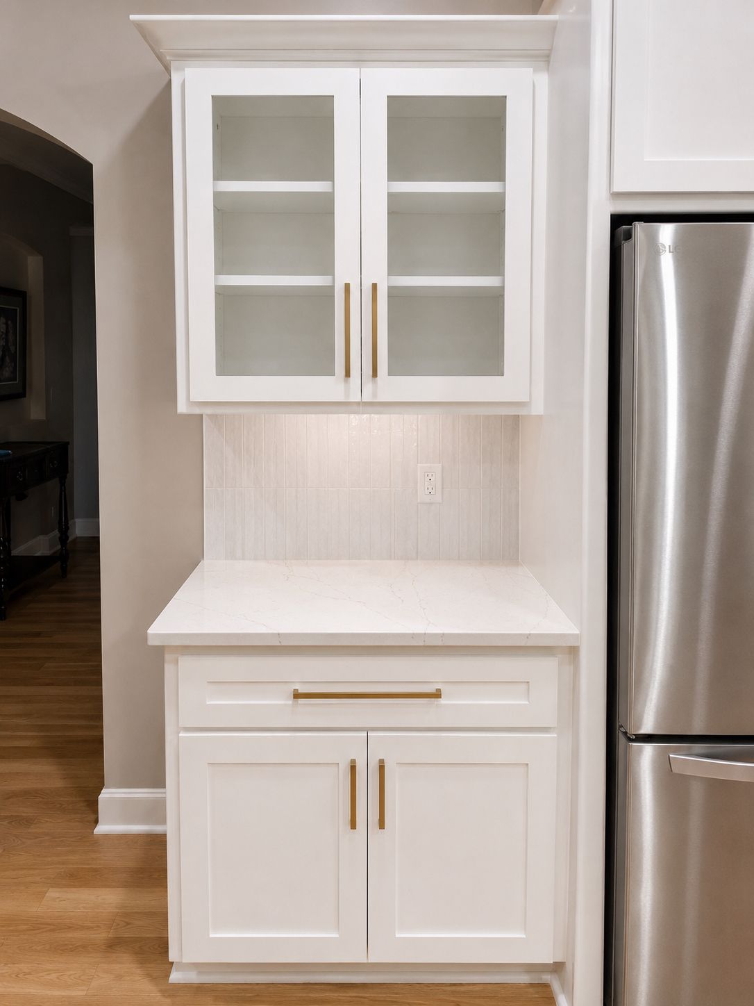 Glass-front cabinetry and finish detail in a Raymore kitchen remodel.